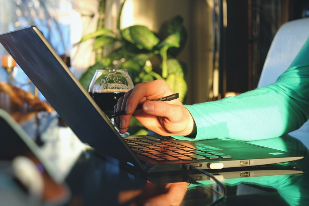 Person taking notes on her laptop